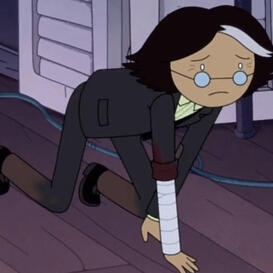 A man with graying brown hair wearing a suit and glasses crawling on all fours